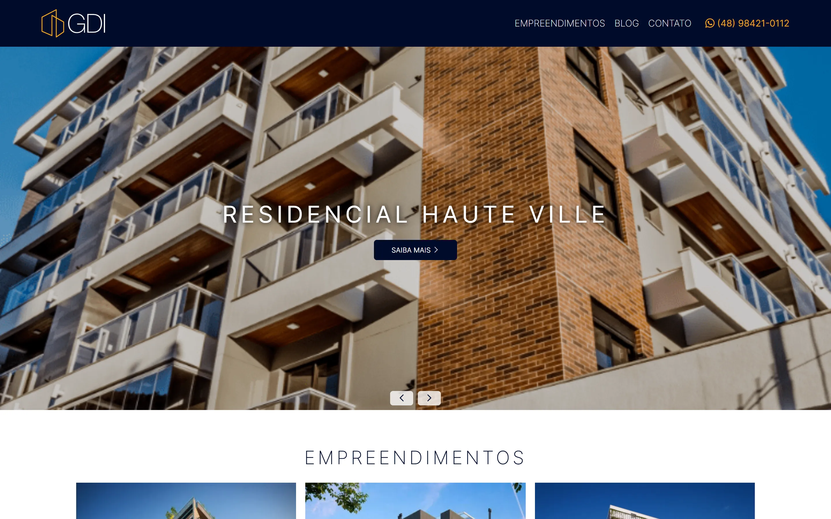 Página inicial do site da GDI Empreendimentos em desktop: um hero em slider ocupando o ecrã, com o nome do empreendimento e um botão Saiba mais.